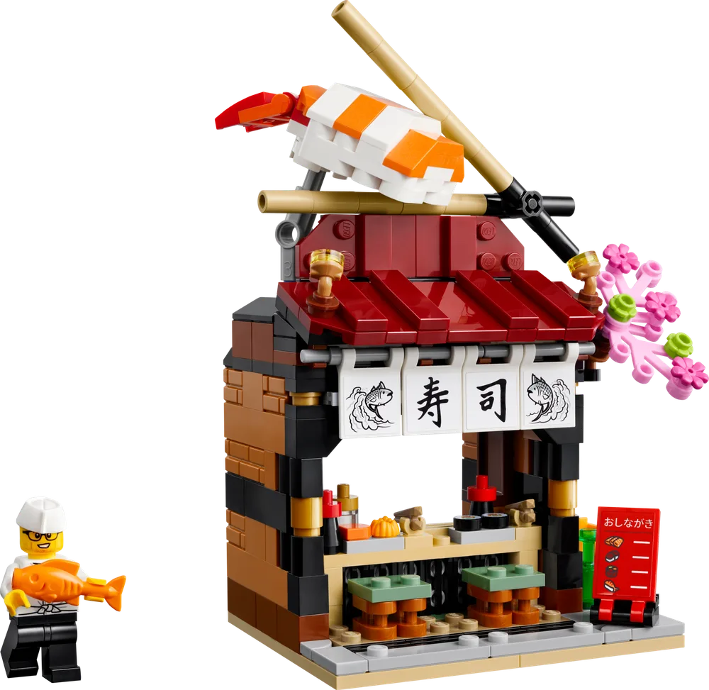 LEGO sushi stall with chef minifigure holding a fish.