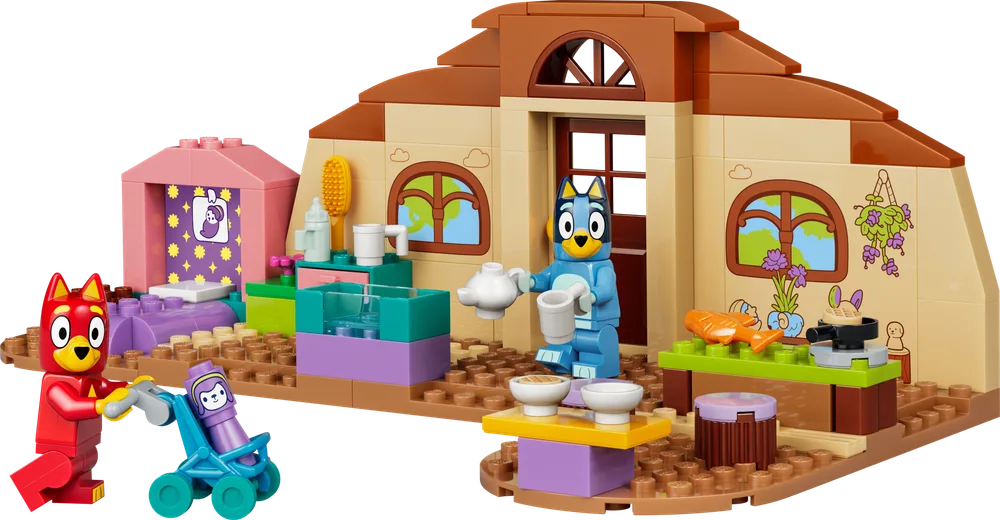 Full view of the LEGO Bluey Heeler house with Bluey pouring tea and Rusty pushing Bingo in a stroller.