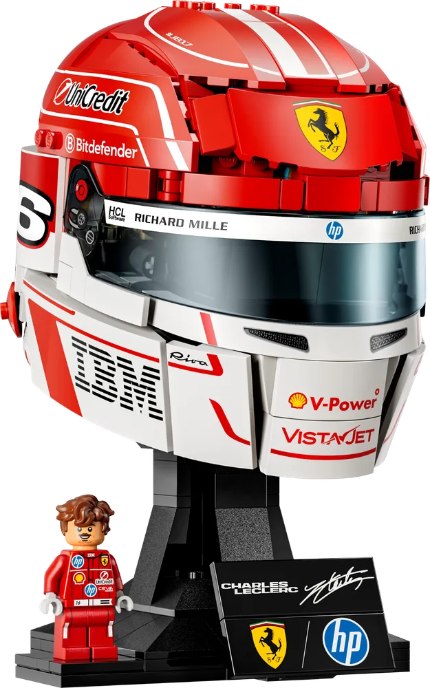 A LEGO replica of Charles Leclerc's Scuderia Ferrari HP racing helmet, with the iconic red and white design and sponsor decals, displayed on a black stand next to a Charles Leclerc minifigure.