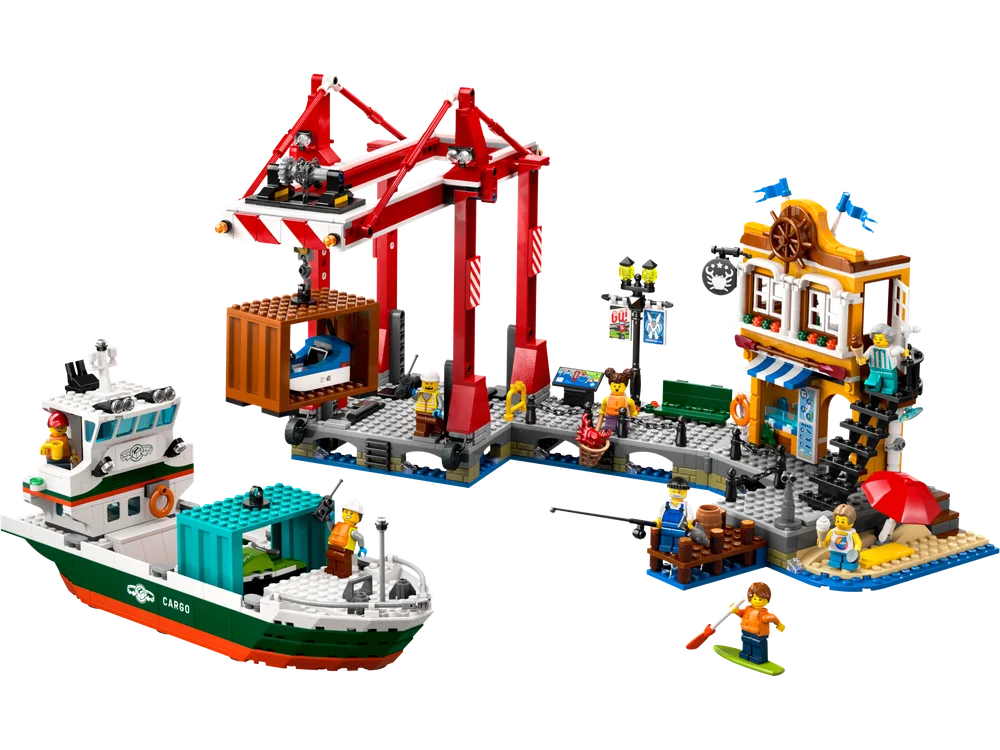 Full view of the LEGO City Harbor with a cargo ship, gantry crane, and a two-story building on a pier.