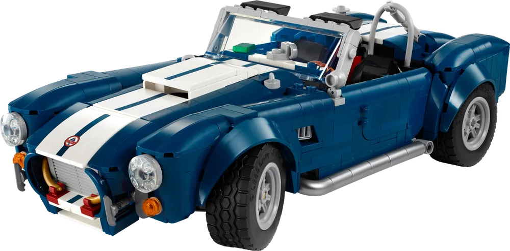 A LEGO Shelby Cobra 427 S/C model in dark blue with white racing stripes, viewed from the front three-quarter angle on a white background.