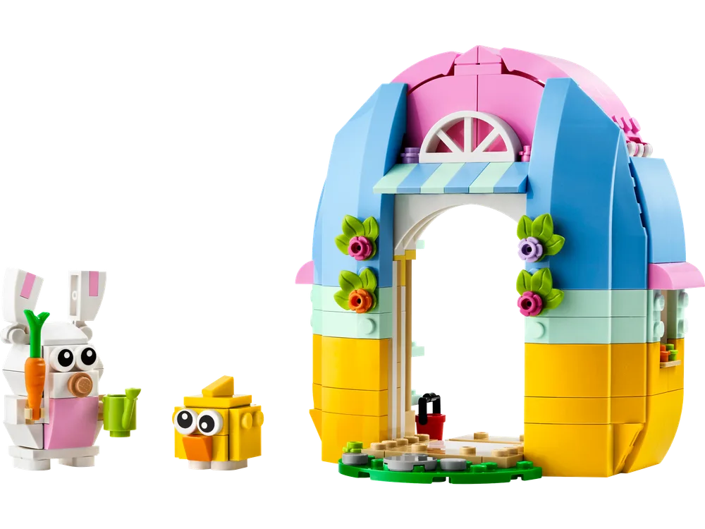 Front view of the LEGO Spring Garden House set, showcasing a vibrant arched structure in pink, blue, and yellow, with a brick-built white bunny holding a green watering can and a yellow chick.