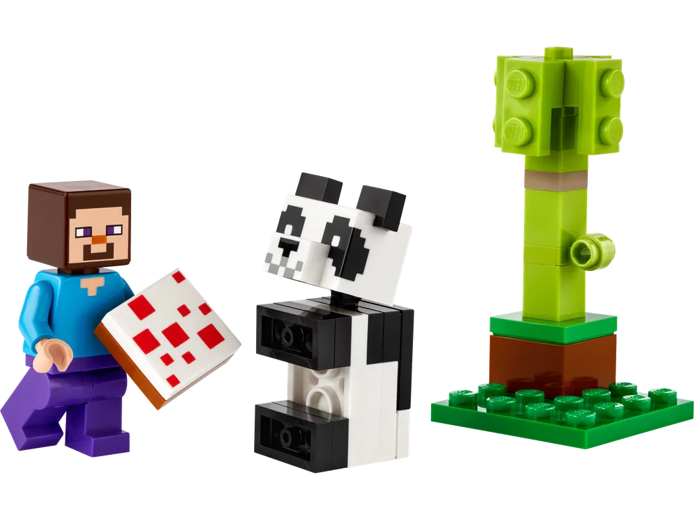 A LEGO Minecraft set featuring a minifigure of Steve holding a red-dotted white cake, a blocky black and white baby panda figure with SNOT construction, and a small green tree with a brown trunk on a green plate.