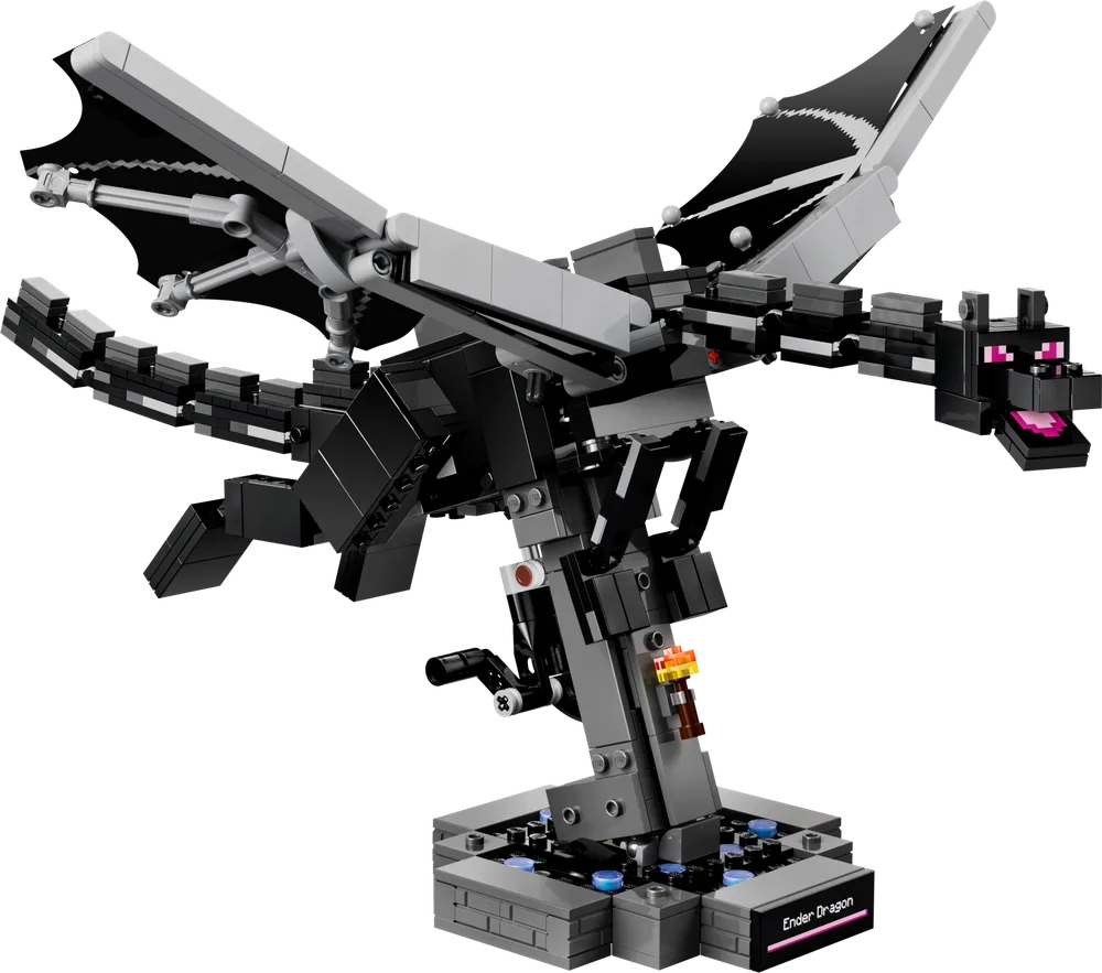 The LEGO Minecraft Ender Dragon set 21595, a large black dragon with grey wings, poised dynamically on a display stand, with purple eyes and a pink tongue.