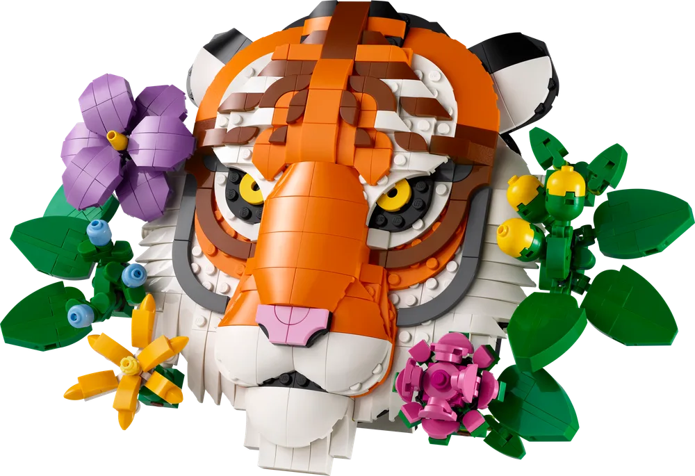 Close-up of the LEGO Art Tiger, adorned with vibrant purple, yellow, and pink brick-built flowers and green foliage, against a white background.