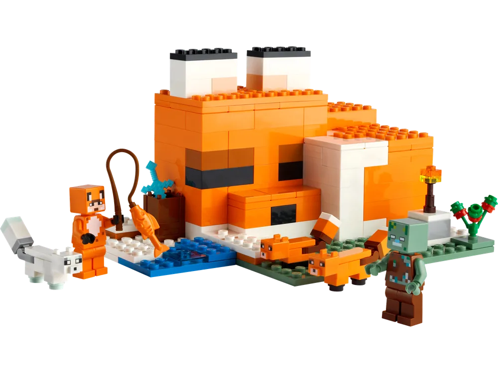 LEGO Minecraft The Fox Lodge set showing an orange fox minifigure fishing in a blue river next to a fox-shaped house, with two baby foxes and a drowned zombie minifigure approaching. An arctic fox is also present.