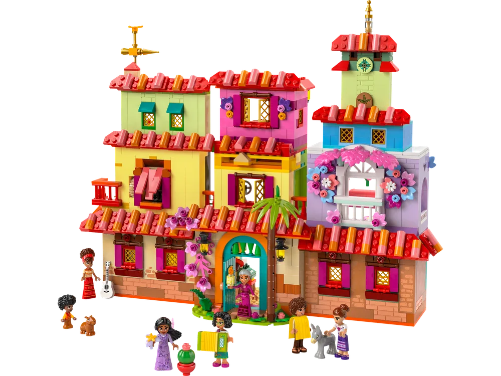 A full front view of the built LEGO Disney Encanto Madrigal House, showcasing its colorful facade and several minifigures posed around the entrance.