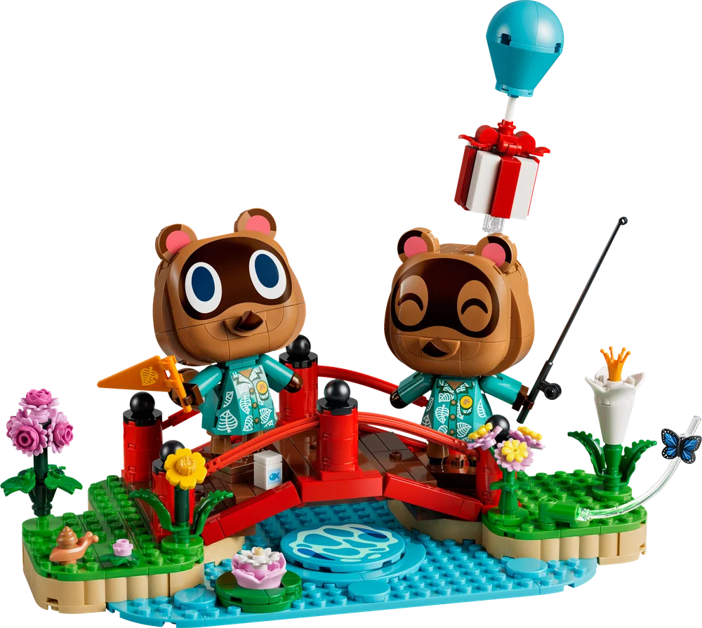 LEGO Animal Crossing Timmy & Tommy's Fun Day Out (77059) set assembled, featuring a red bridge, two tanuki minifigures, a blue pond, and various plants.