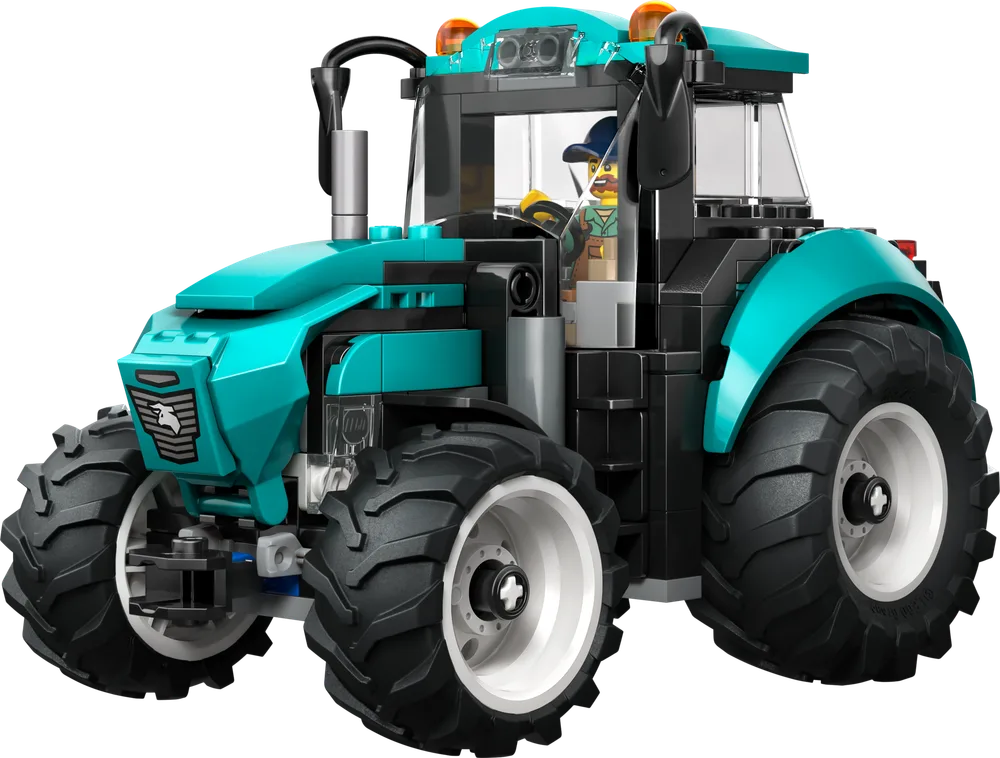 Side profile of a teal and black LEGO City tractor with large studded wheels, driven by a minifigure.