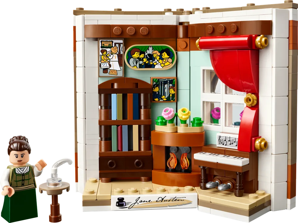 A Lego set depicting an open book that reveals a miniature room with a minifigure of Jane Austen, a fireplace, a piano, and a bookshelf.