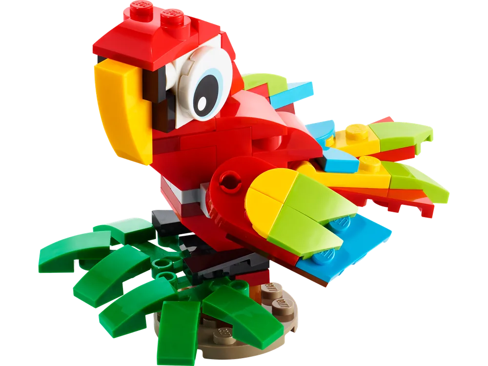 A detailed, brick-built red, yellow, blue, and green parrot perched on a brown base with green leaf elements.