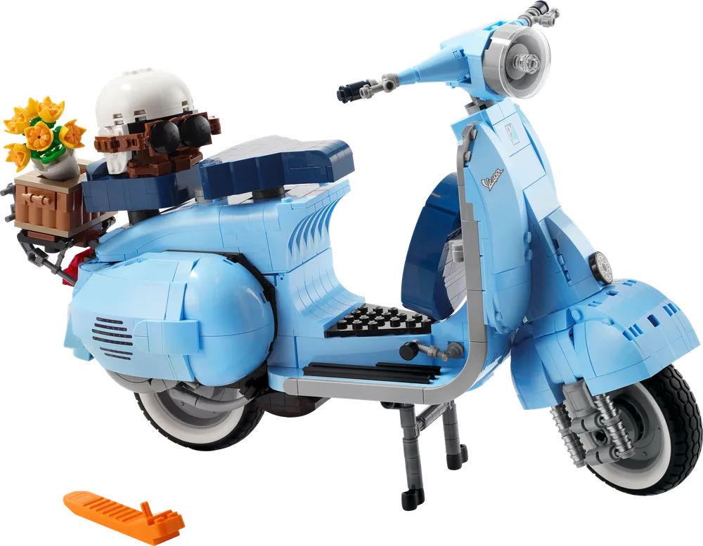 Full side view of the LEGO Creator Expert Vespa 125 scooter, in light blue, with a helmet and flowers on the back rack.