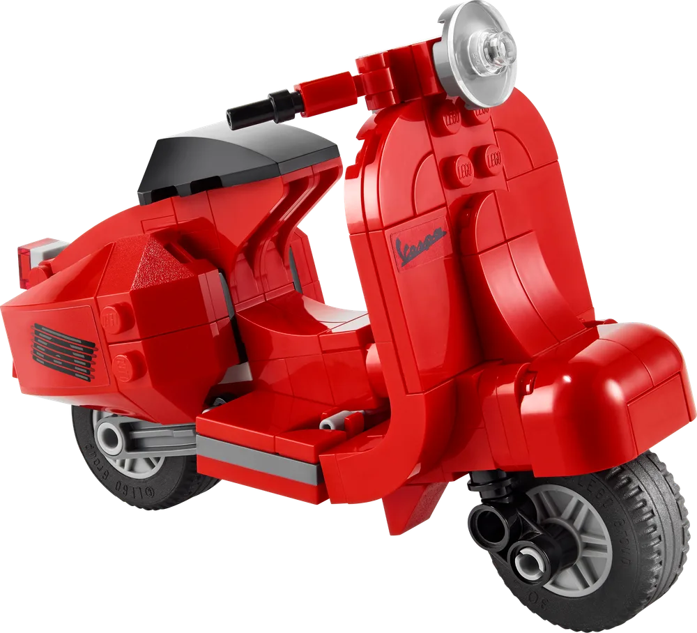 Close-up, angled view of the red LEGO Creator Vespa scooter, showcasing its smooth curves and details.