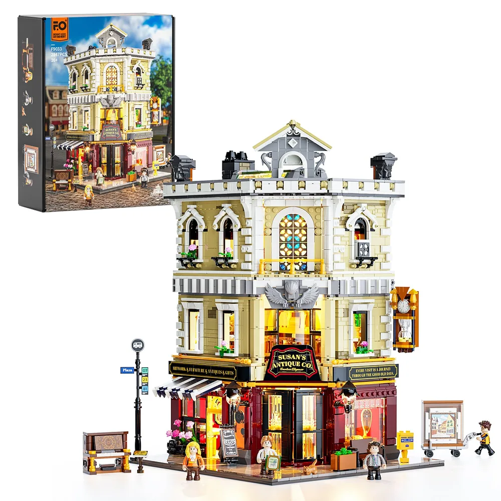 Front view of the Lumibricks Antique Co F9033 set, showing the full build with its modular design, tan and dark red facade, and detailed street-level elements, presented alongside its product box.