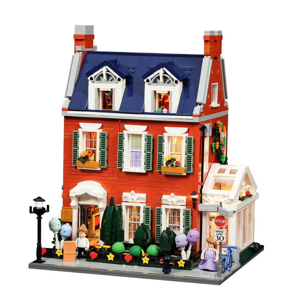 Fully assembled Lumibricks Redbrick Row House 15009 from the front, showcasing its warm, integrated lighting on a white background.