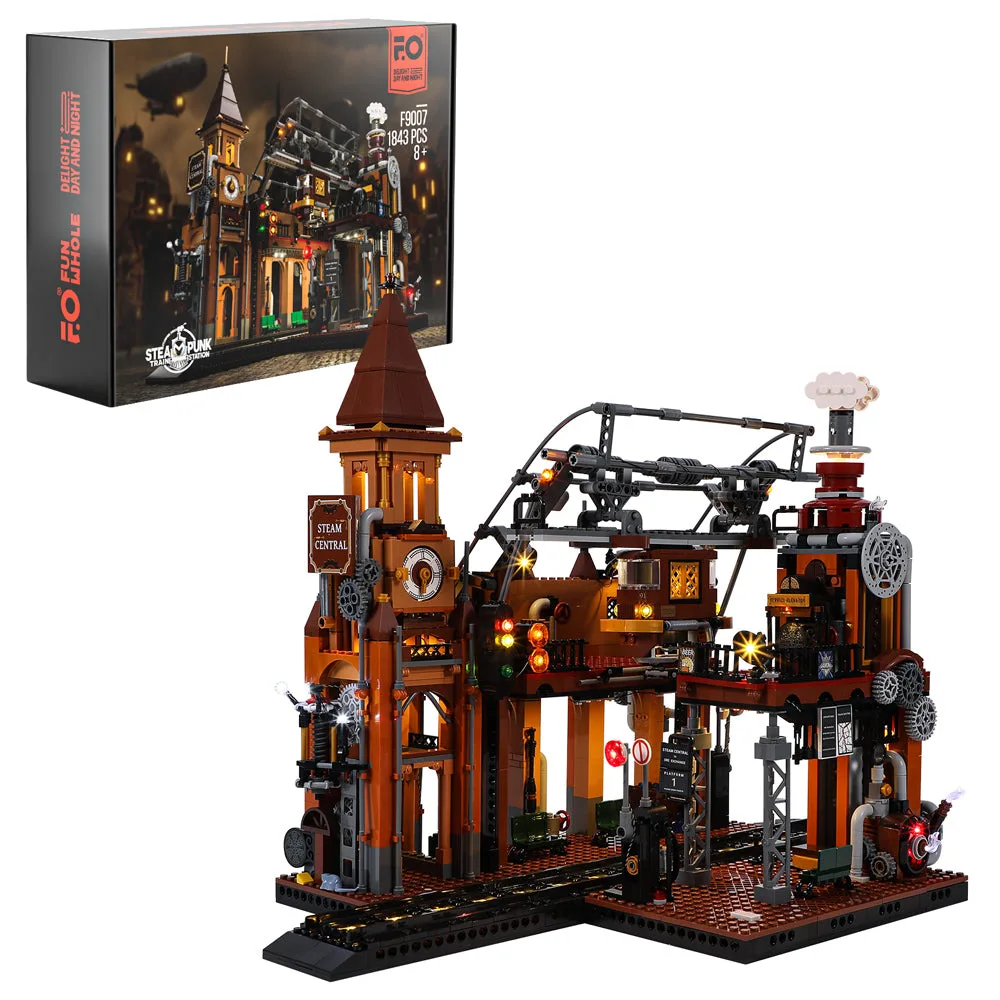 Lumibricks Steampunk Train Station F9007 set box and fully built model illuminated against a white background. The model shows a multi-level station with a clock tower, gantry, and tracks.