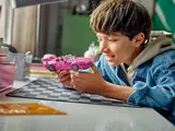 Child playing with Lego S2000.