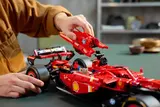 Hand removing engine cover of Lego Ferrari SF-24 F1 car.