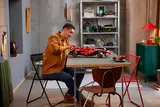 Man building Lego Ferrari SF-24 F1 car.