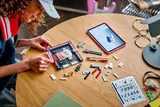Person building LEGO soccer frame.