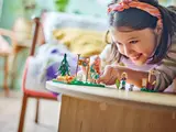 Child playing with LEGO Friends set.