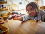 Child playing with Jedi Interceptor.