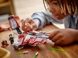 Child placing minifigure in Interceptor.
