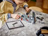 Child building LEGO set with digital instructions.