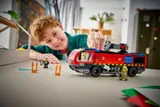 Child playing with LEGO fire truck.