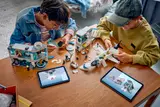 Children building with digital instructions.