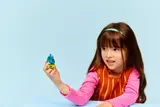 Child examining the Peacock Minifigure.