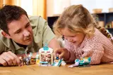 Adult and child playing with LEGO Frozen set.