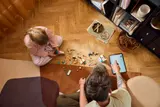 Overhead view of LEGO Frozen playtime with tablet.