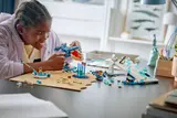 Person playing with full LEGO Antarctic Animals Science Kit.
