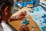 Person building LEGO research boat.