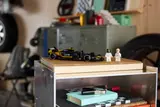 APXGP car and minifigures on a shelf.