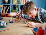 Child playing with LEGO Aragog.