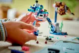 Child assembling LEGO diving vehicle.