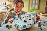Child playing with LEGO polar bear and iceberg.