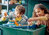 Kids playing with floating LEGO ship.