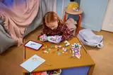 Girl playing with wedding boat set.