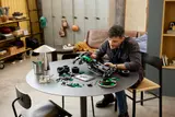 Man building LEGO Technic F1® car.