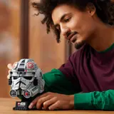 Person examining AT-AT Driver Helmet.