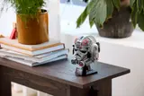 AT-AT Driver Helmet on a desk with plants.