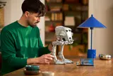 Man holding LEGO AT-ST model.