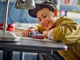 Child playing with LEGO Audi S1 e-tron quattro.