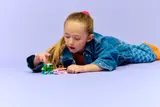 Child playing with LEGO Friends Axolotl Adventure Boat set.