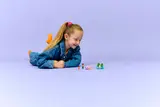 Child observing the LEGO Axolotl Adventure Boat set.
