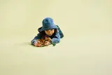 Child playing with LEGO Aquilops on floor.