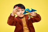 Child playing with Pteranodon and crab.